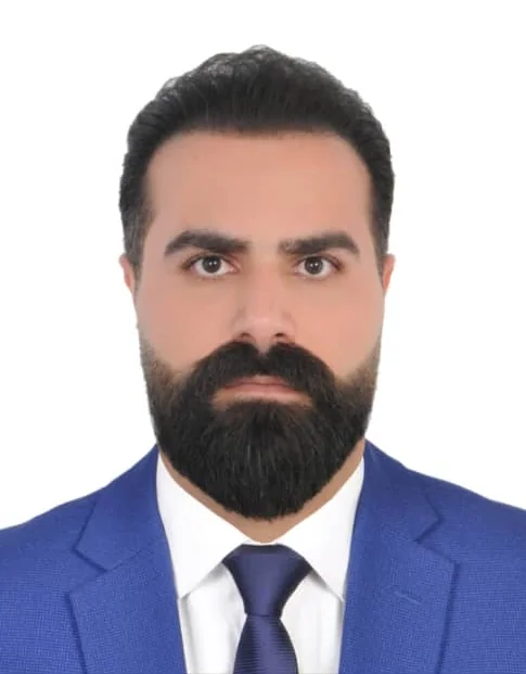 Portrait of Reza Shams in a blue suit and tie